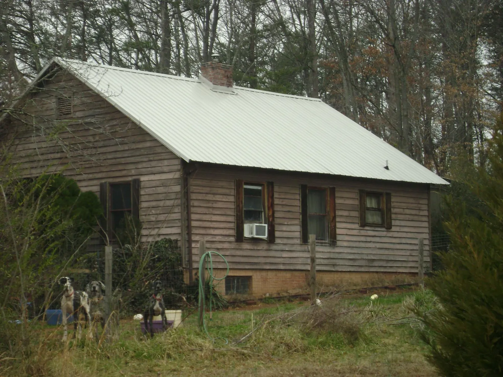 White metal roof on an old wood sided farmhouse, from a Asphalt Shingle Roof Repair job in Vermillion